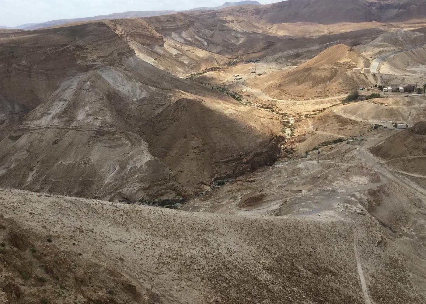 Winding desert tracks and the access road in the ravines below the Masada cliff